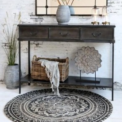 Round black and natural rug