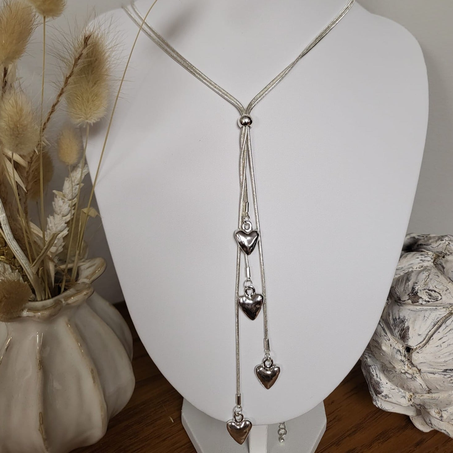 Long Silver necklace with four hearts